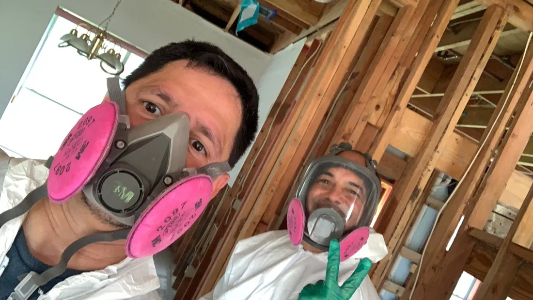 LaborNOW crew members wearing respirators and PPE on a restoration jobsite
